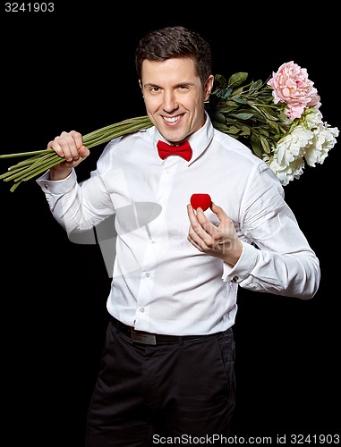 Image of The elegant man with a ring and flowers