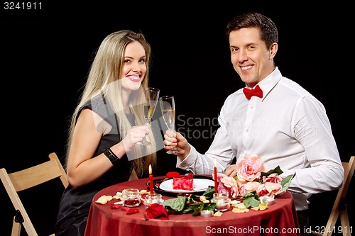 Image of Portrait Of Romantic Couple Toasting white Wine At Dinner