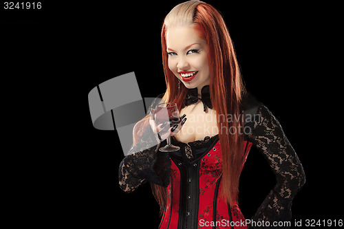 Image of Portrait of redheaded gothic girl with glass