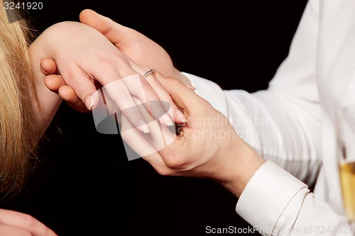 Image of  shot of Man wearing ring to woman
