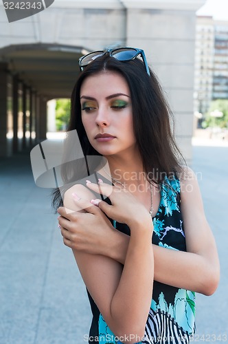 Image of Beautiful girl in bright dress at urban background