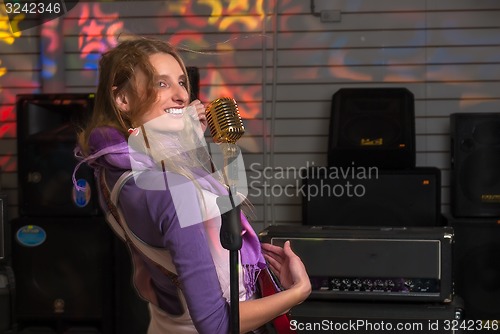 Image of Attractive woman with electric guitar