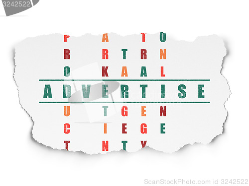 Image of Advertising concept: word Advertise in solving Crossword Puzzle