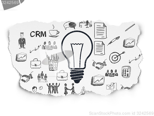 Image of Business concept: Light Bulb on Torn Paper background