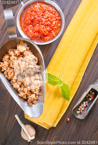 Image of dough for lasagna and ingredients for lasagna