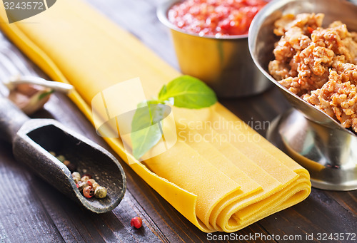 Image of dough for lasagna and ingredients for lasagna