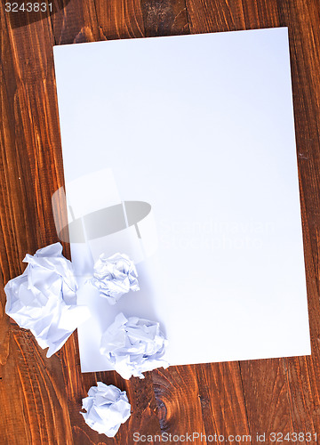 Image of paper on wooden background