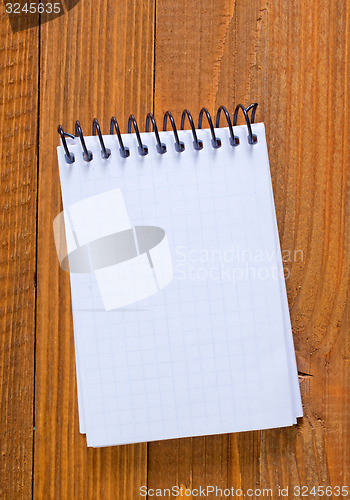 Image of note on wooden background