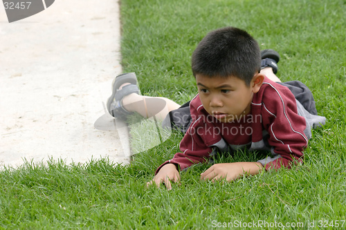 Image of Boy resting on the grass