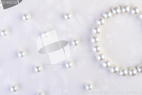 Image of White pearls necklace on white paper 