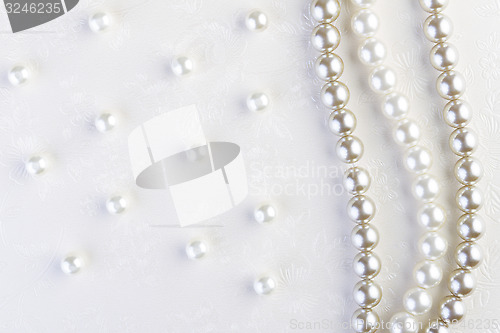 Image of White pearls necklace on white paper  