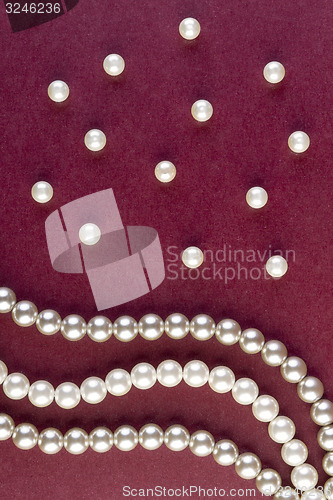 Image of Silver and White pearls necklace on dark red 