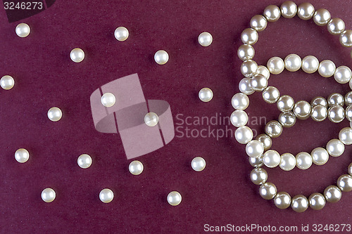 Image of Silver and White pearls necklace on dark red  