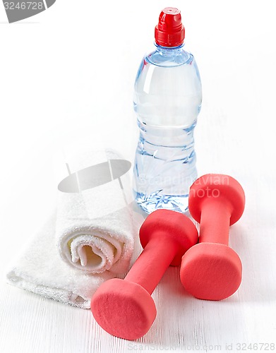 Image of Fitness equipment dumbbells, towel and bottle of water