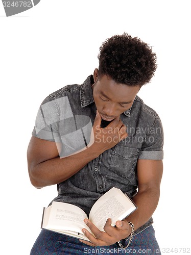 Image of Black man reading book.