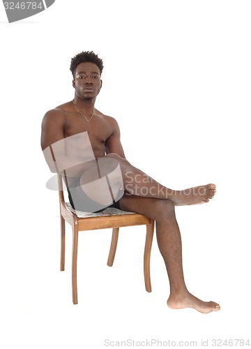 Image of African man sitting on chair.