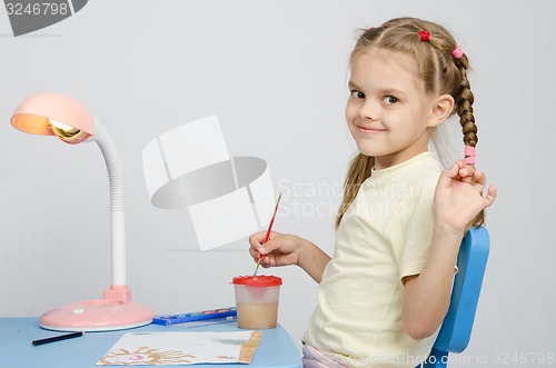 Image of Six year old girl draws paints and waves