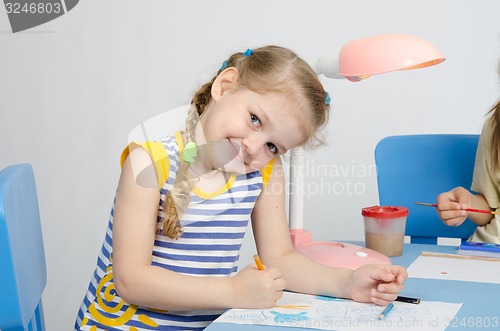 Image of Happy little girl drawing pencils