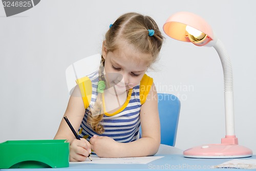 Image of The girl loves to draw with pencils