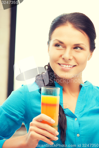 Image of beautiful woman with glass of juice