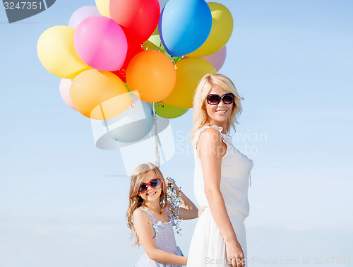 Image of mother and child with colorful balloons