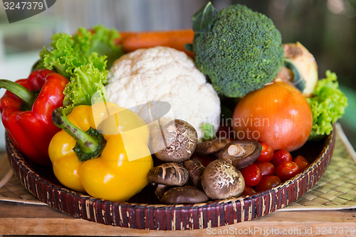 Image of basket of fresh ripe vegetables at kitchen