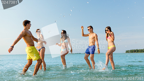 Image of happy friends having fun on summer beach