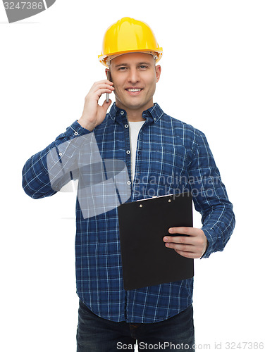 Image of smiling builder in helmet calling on smartphone