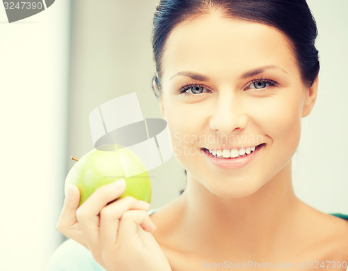 Image of beautiful woman in the with an apple