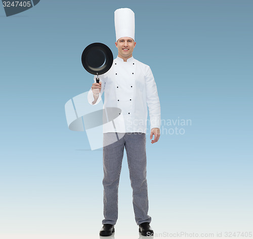 Image of happy male chef cook holding frying pan