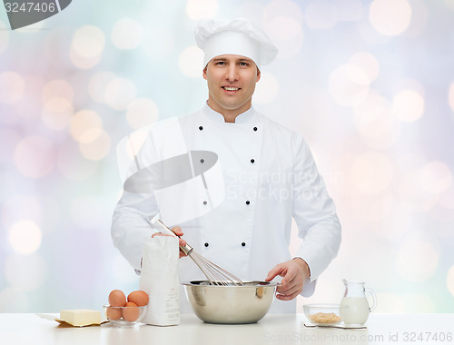 Image of happy male chef cook baking