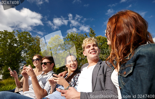 Image of students or teenagers with smartphones at campus