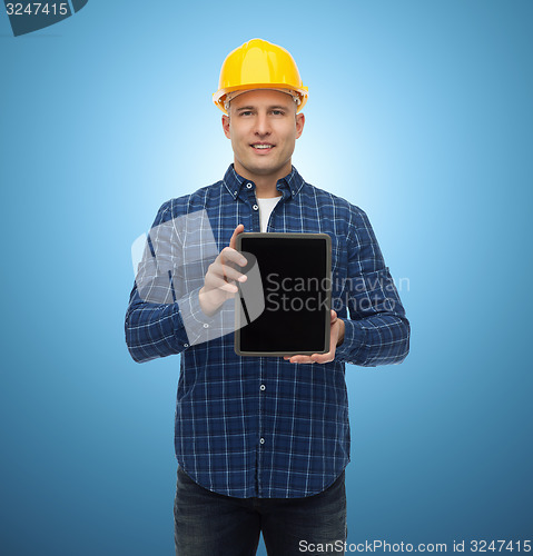 Image of smiling male builder in helmet with tablet pc