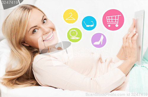 Image of happy woman with laptop shopping online at home
