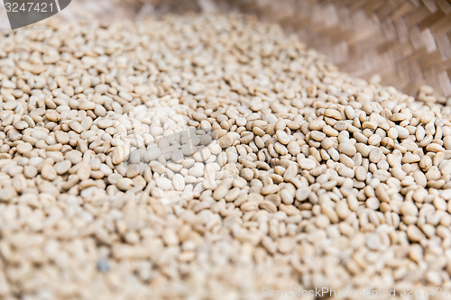 Image of close up of unroasted coffee beans in basket