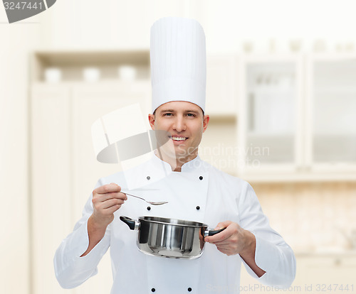 Image of happy male chef cook with pot and spoon