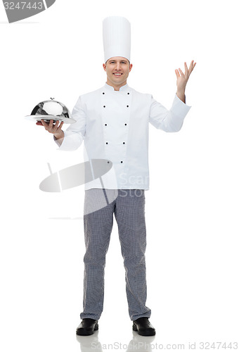 Image of happy male chef cook holding cloche