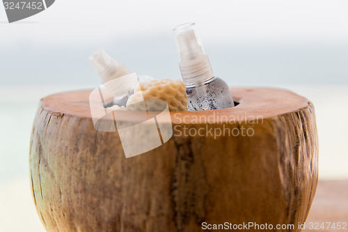 Image of bowl with moisturizing spray at hotel beach or spa