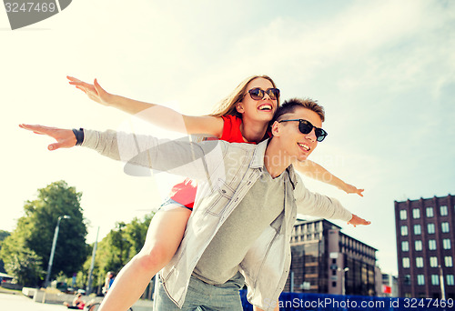 Image of smiling couple having fun in city