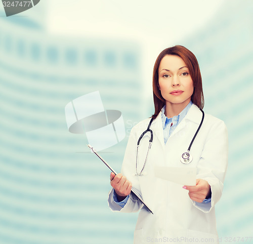 Image of calm female doctor with clipboard