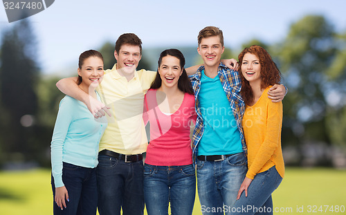 Image of group of smiling teenagers over green park