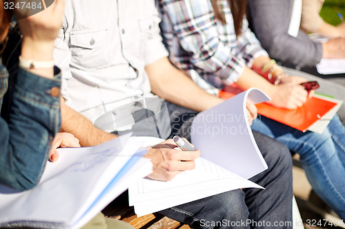 Image of close up of students with notebooks at campus