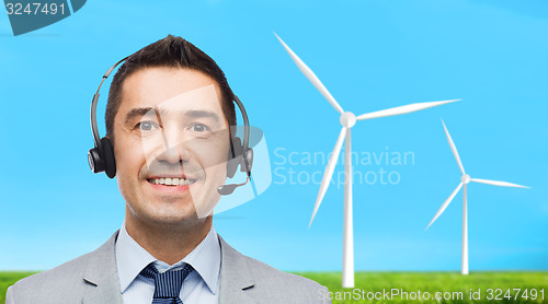 Image of smiling businessman in headset