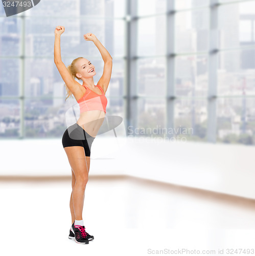 Image of happy beautiful sporty woman dancing