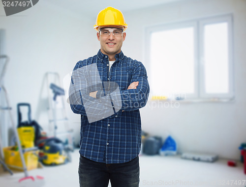 Image of smiling male builder or manual worker in helmet