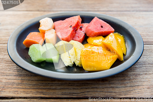 Image of plate of fresh juicy fruits at asian restaurant