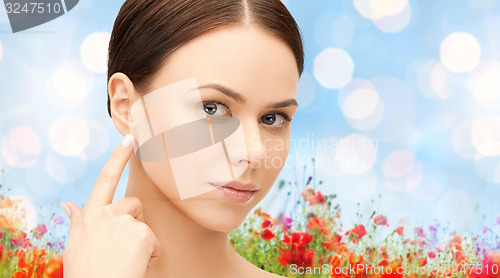 Image of face of beautiful woman touching her ear