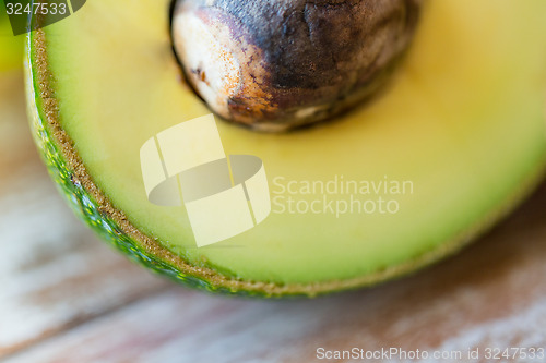 Image of close up of ripe avocado with bone on table