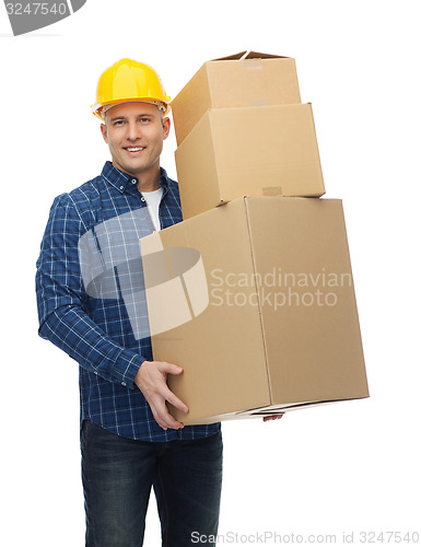 Image of smiling man in helmet with cardboard boxes