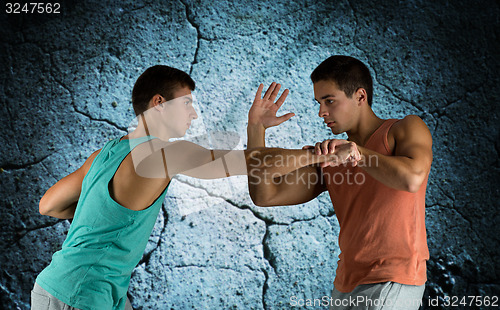 Image of young men fighting hand-to-hand